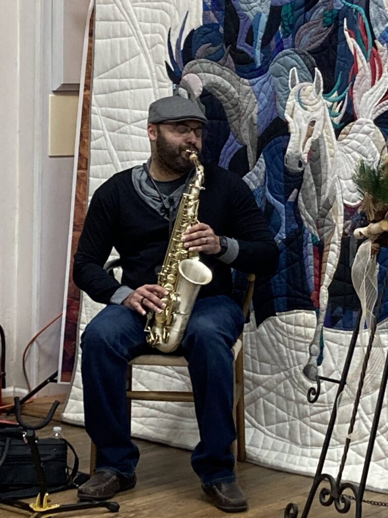 David Collins playing saxophone at reception